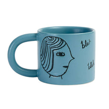 Tasse mit Gesichtern in Türkis