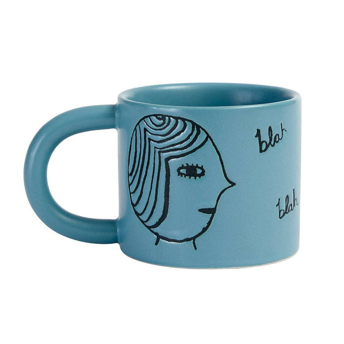 Tasse mit Gesichtern in Türkis